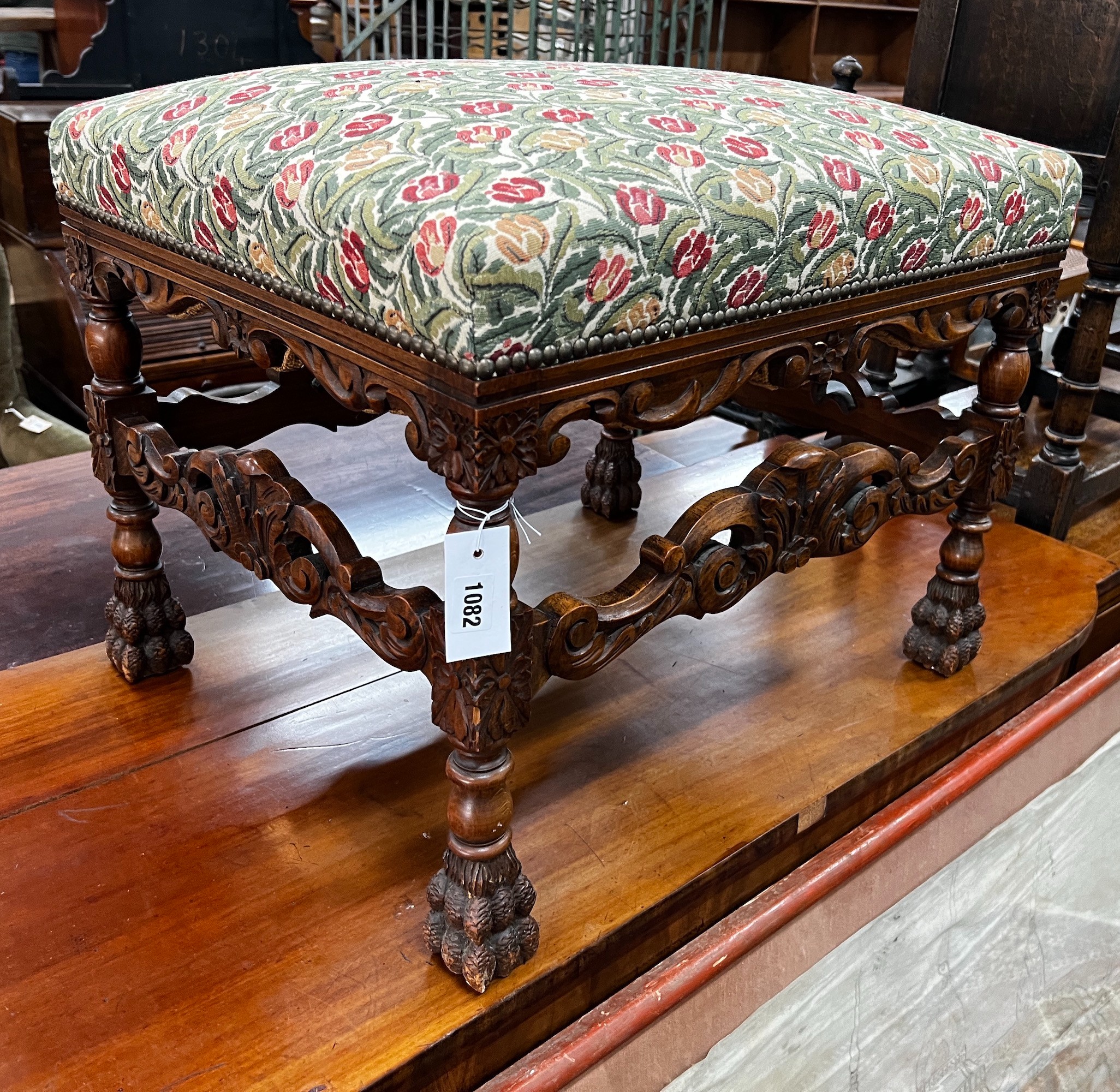 An early 20th century Jacobean revival carved beech dressing stool, length 60cm, depth 48cm, height 49cm